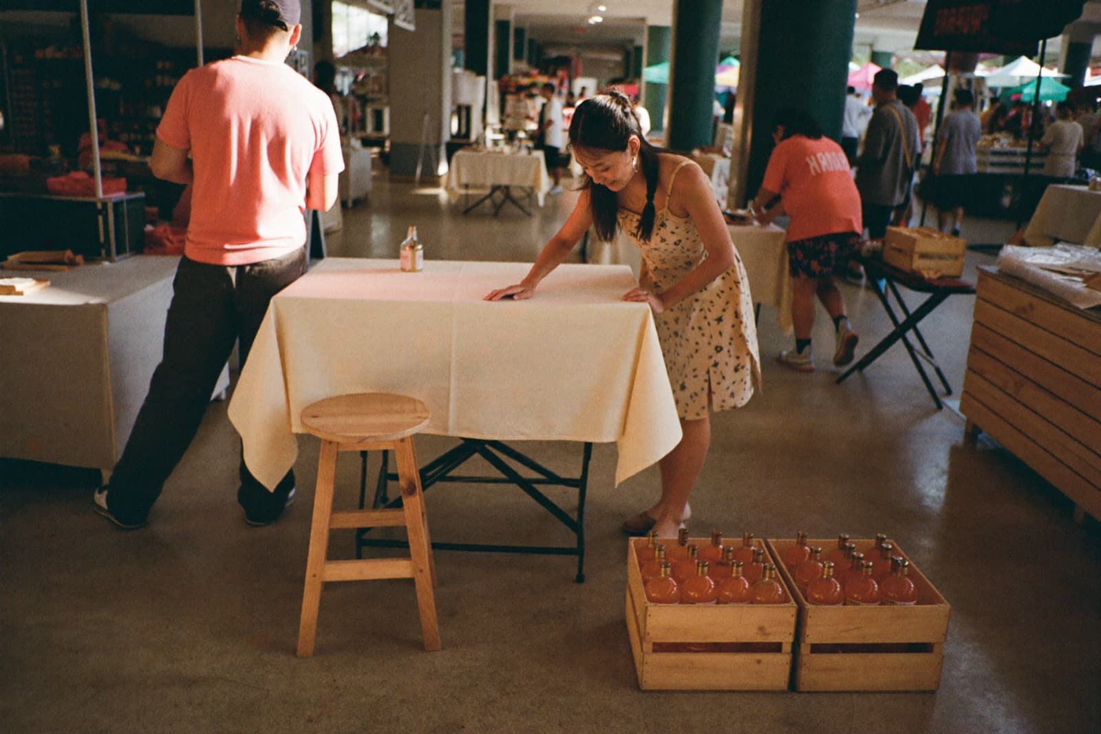A founder setting up her booth before a Singapore market opens