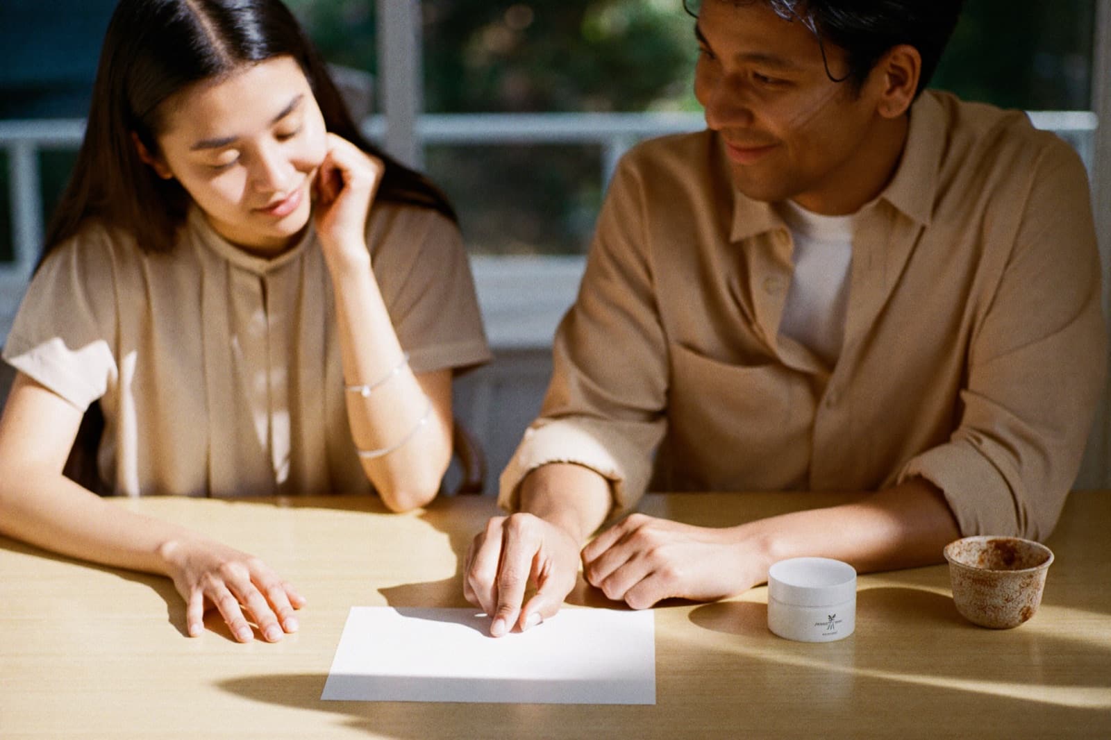 A brand founder and adviser reviewing a compliance checklist together at a bright table
