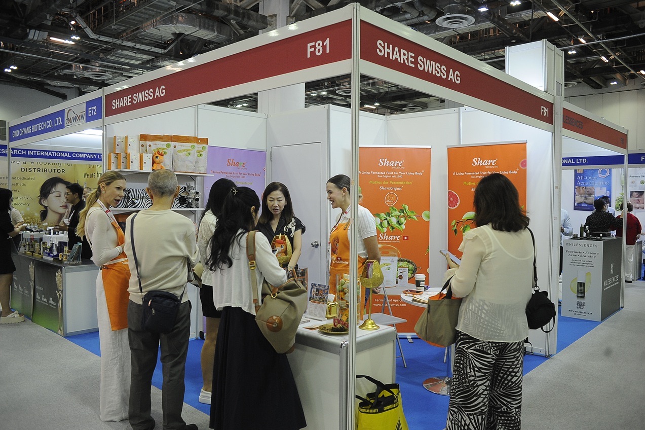 Visitors talking to staff at a Swiss skincare exhibitor's booth at BeautyAsia 2026 trade show, Marina Bay Sands Expo, Singapore
