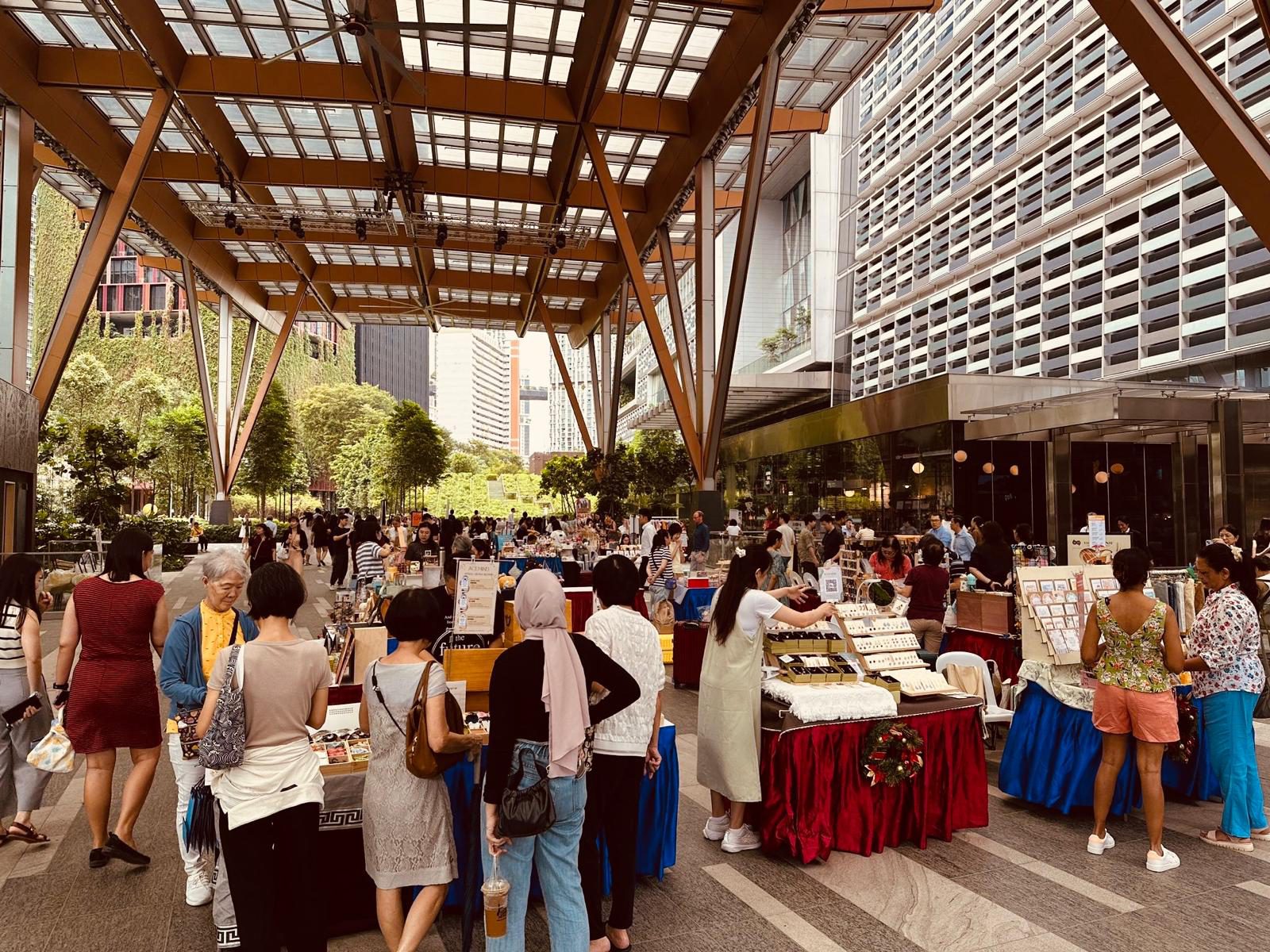 Visitors browsing handmade craft stalls at a Crafters' Market at Guoco Tower, Singapore