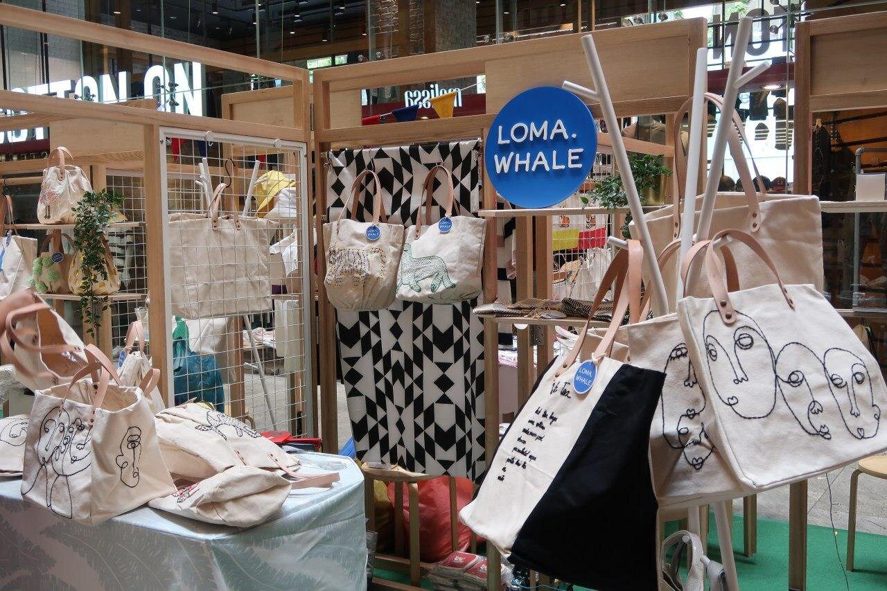 Shoppers browsing design and craft booths at a Makers' Market by Invade, Singapore