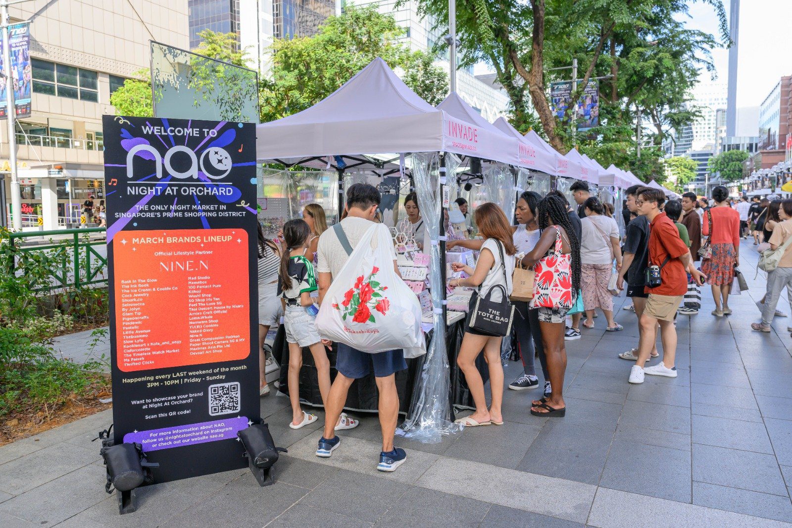Shoppers at booths during Night At Orchard