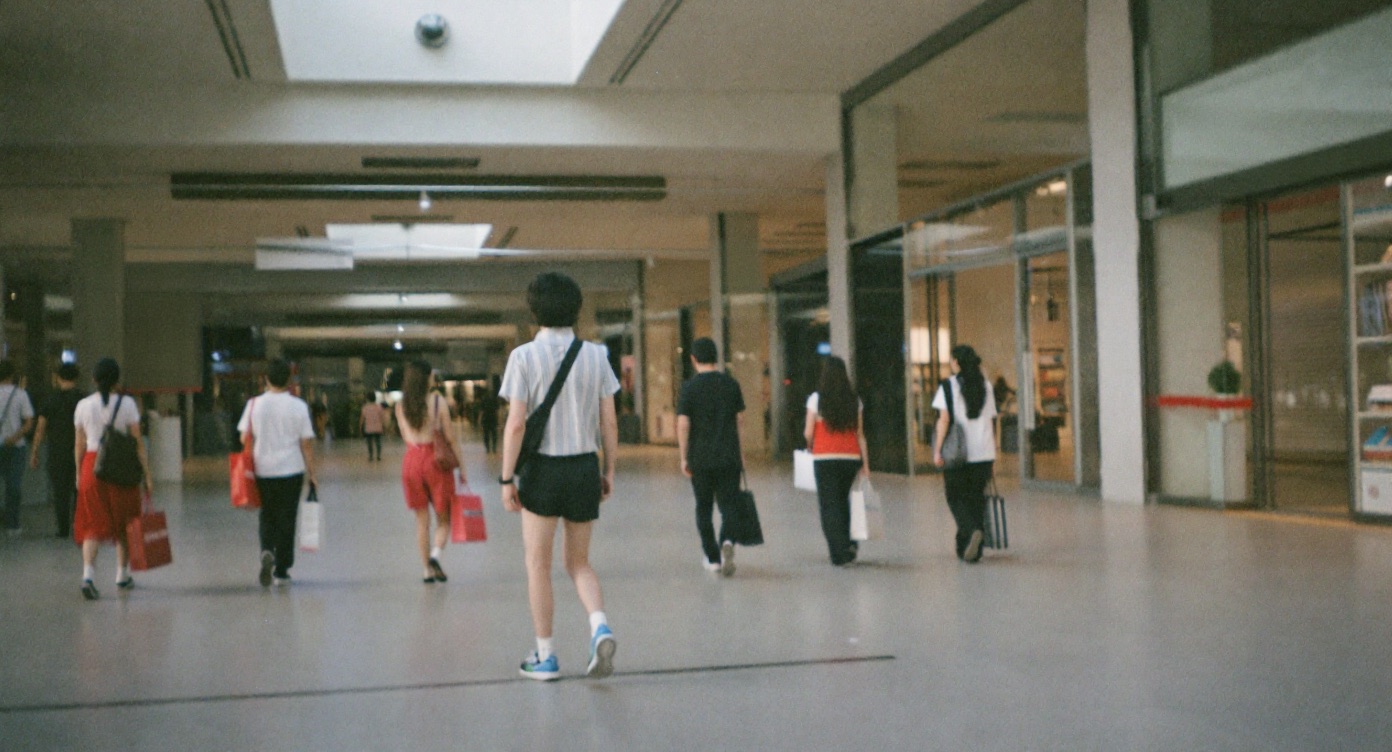 Shoppers walking past retail units on the basement level of Jewel Changi Airport